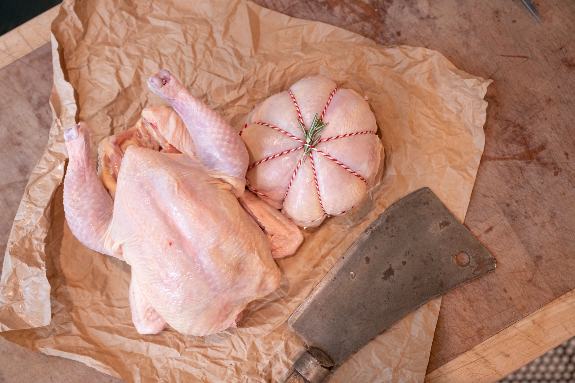 Raw free-range chicken with meat cleaver