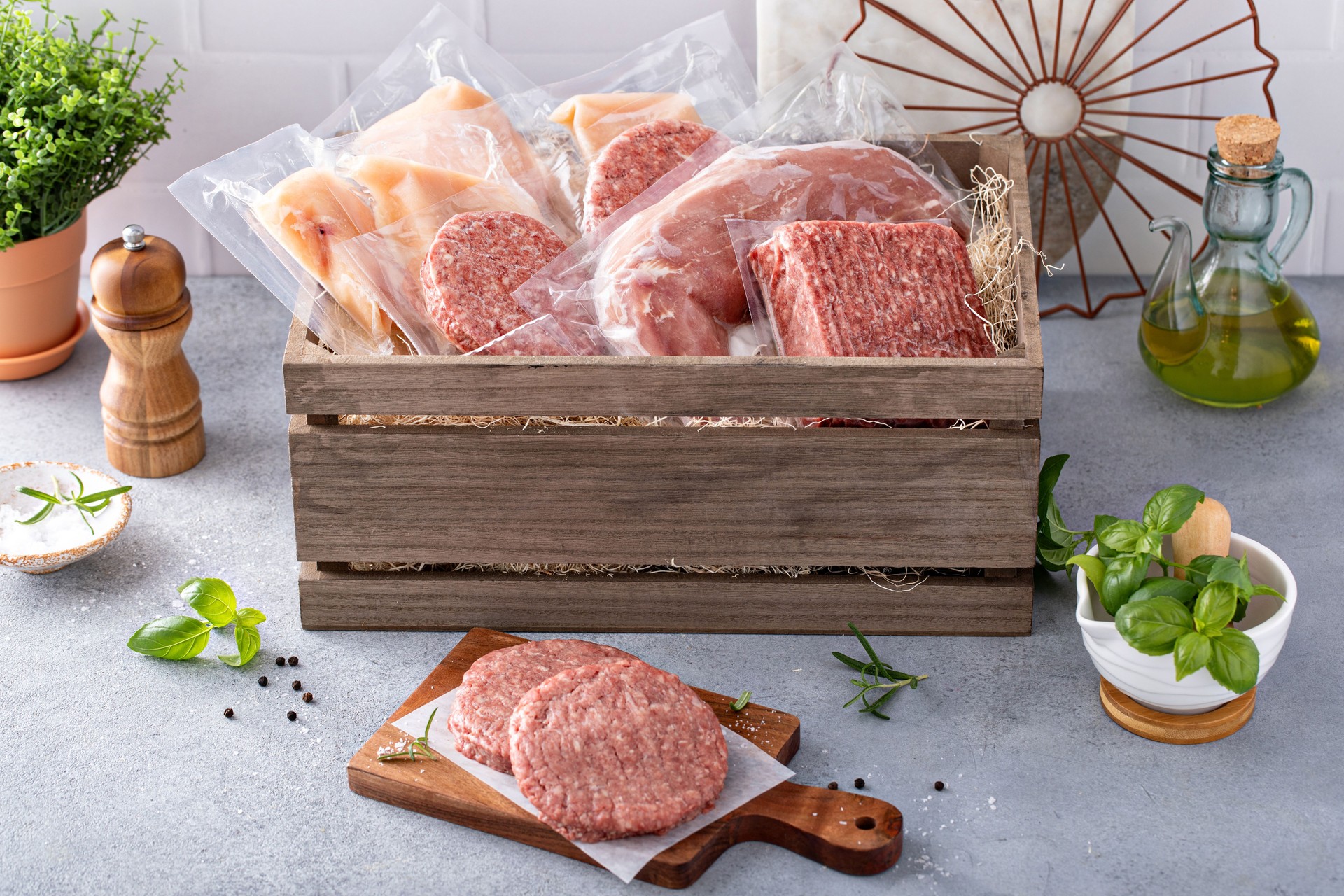 Meat delivery box, variety of meat chops and packages in a wooden crate